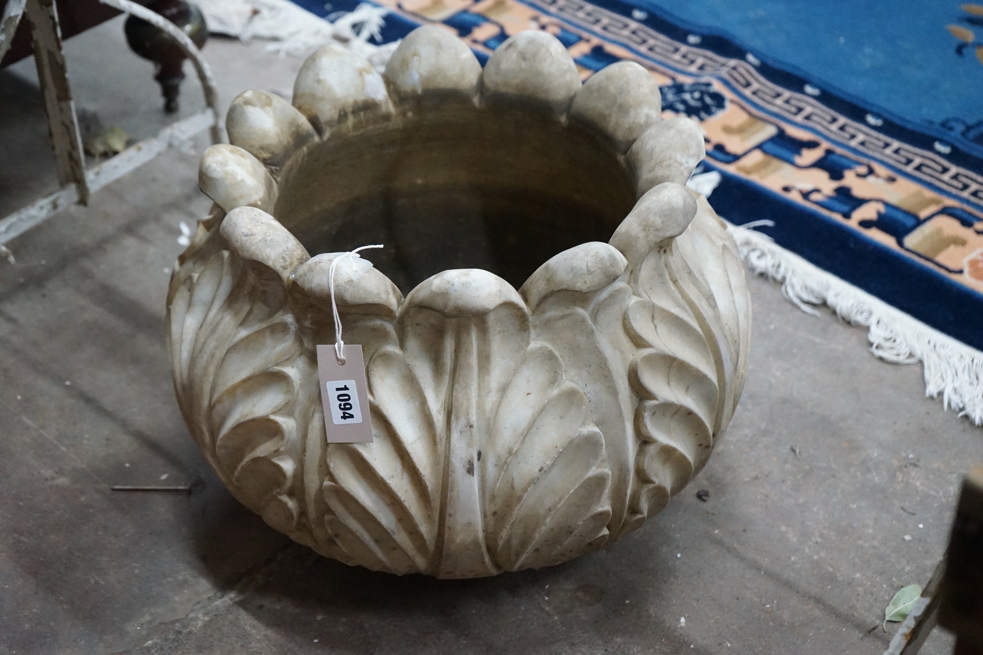 A pair of carved stone acanthus urns, diameter 46cm, height 32cm